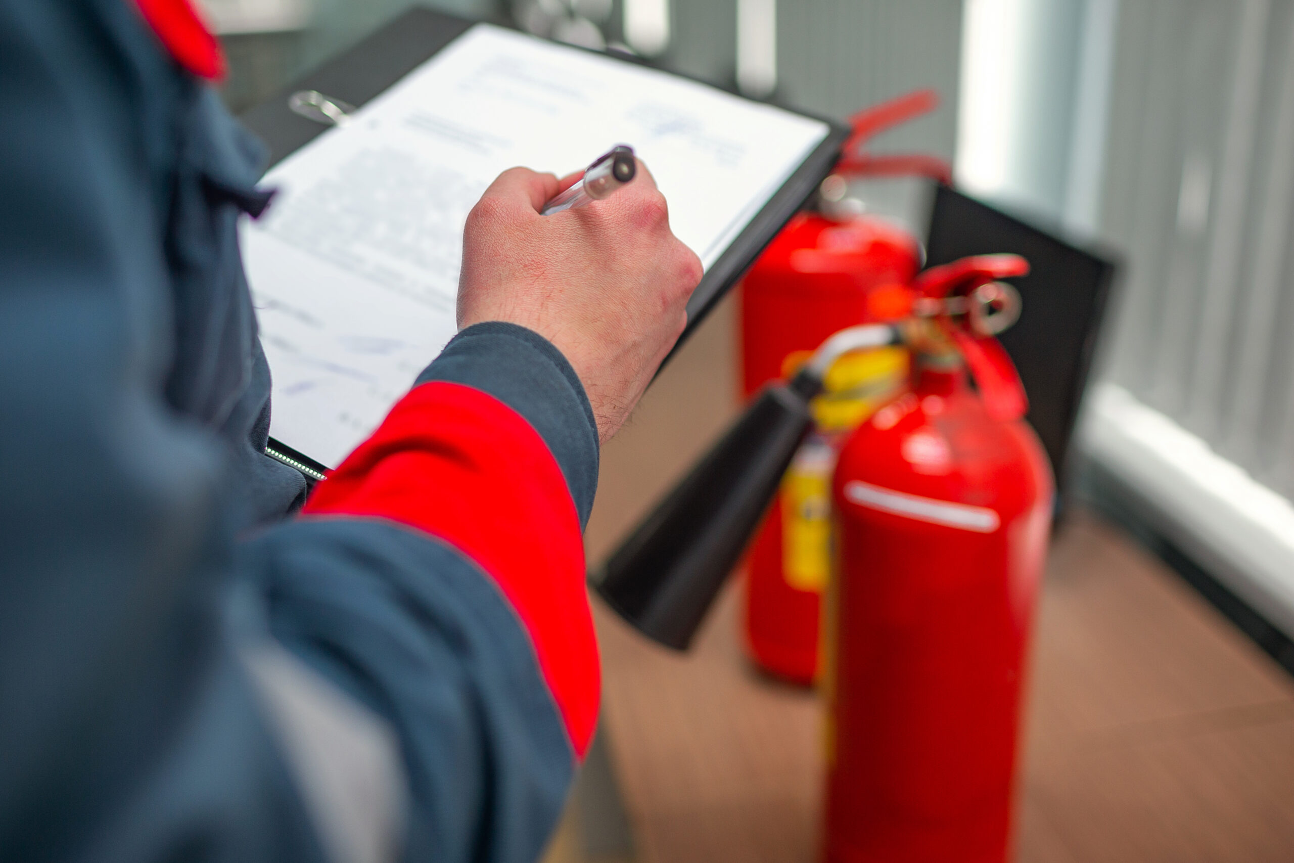 Technician recording a fire extinguisher inspection